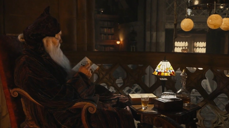 Dumbledore reading in a pub with the Elder Wand sitting near him in Harry Potter and the Philosopher's Stone