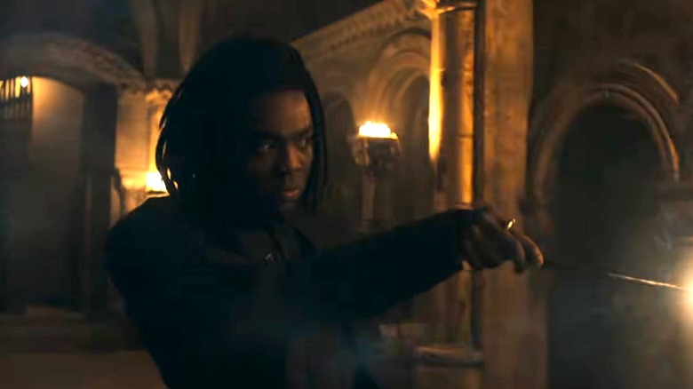 Snape casting a spell in the Hogwarts hallway in Harry Potter and the Philosopher's Stone