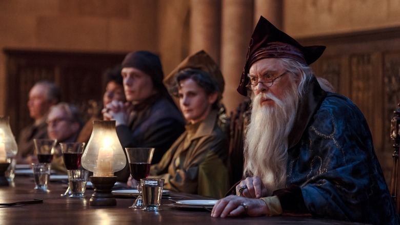 Dumbledore looking at someone with other Hogwarts professors behind him in Harry Potter and the Philosopher's Stone