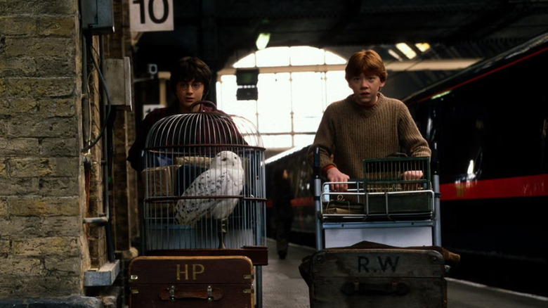 Harry and Ron wheeling their trolleys at King's Cross in Harry Potter and the Chamber of Secrets
