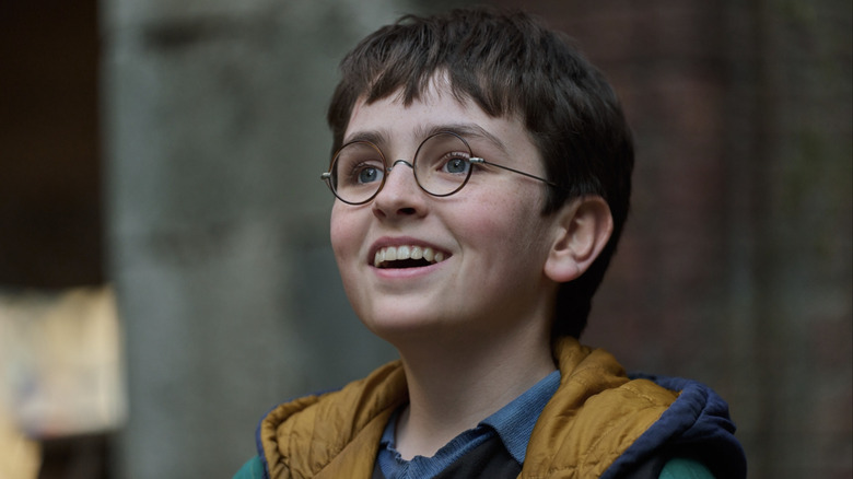 Harry grinning happily in the HBO Harry Potter TV series