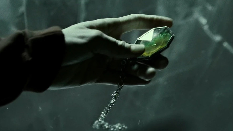 A hand holding Regulus' locket in Harry Potter and the Half-Blood Prince
