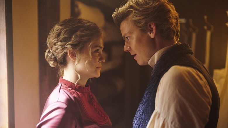 Maia Mitchell as Belle and Thomas Brodie-Sangster as Jack gazing at each other in The Artful Dodger