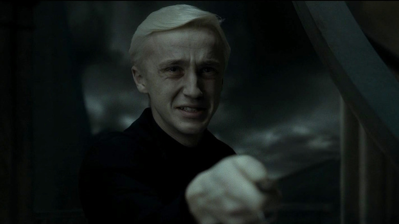 Tom Felton as Draco Malfoy wielding a wand in Harry Potter and the Half-Blood Prince