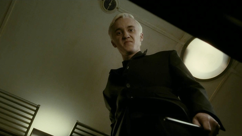 Tom Felton as Draco Malfoy glaring downward in Harry Potter and the Half-Blood Prince