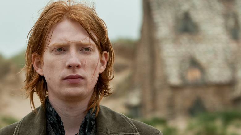 A scarred Bill Weasley (Domhnall Gleeson) stands by his cottage in Harry Potter and the Deathly Hollows: Part 2