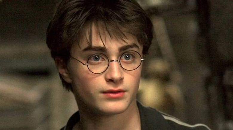 Harry Potter (Daniel Radcliffe) stands in a stone corridor in Harry Potter and the Prisoner of Azkaban