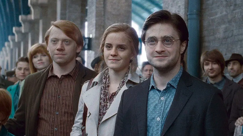 Daniel Radcliffe as Harry Potter standing with Emma Watson as Hermione and Rupert Grint as Ron in the epilogue of Harry Potter and the Deathly Hallows: Part Two
