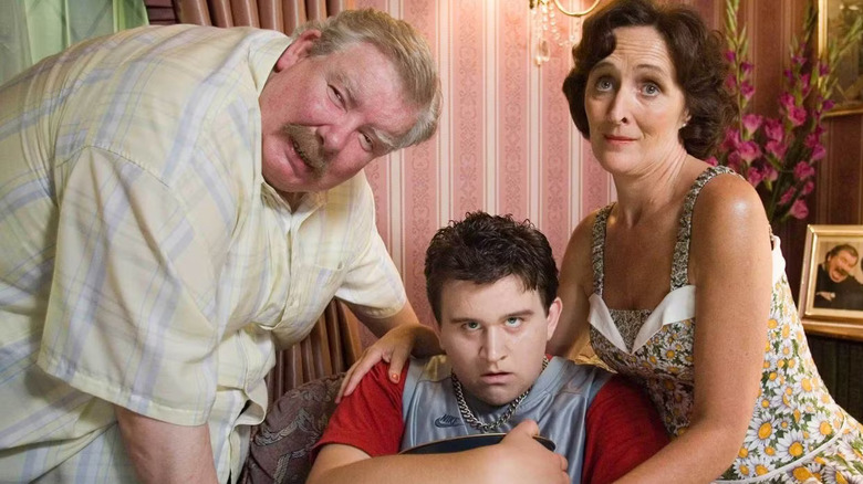 Richard Griffiths as Vernon Dursley, Fiona Shaw as Petunia Dursley, and Harry Melling as Dudley Dursley in Harry Potter and the Order of the Phoenix, with Vernon and Petunia surrounding a sick-looking Dudley.