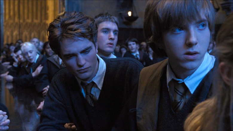 Cedric at the Hufflepuff table, hearing his name called out for the Triwizard tournament, in Harry Potter and the Goblet of Fire