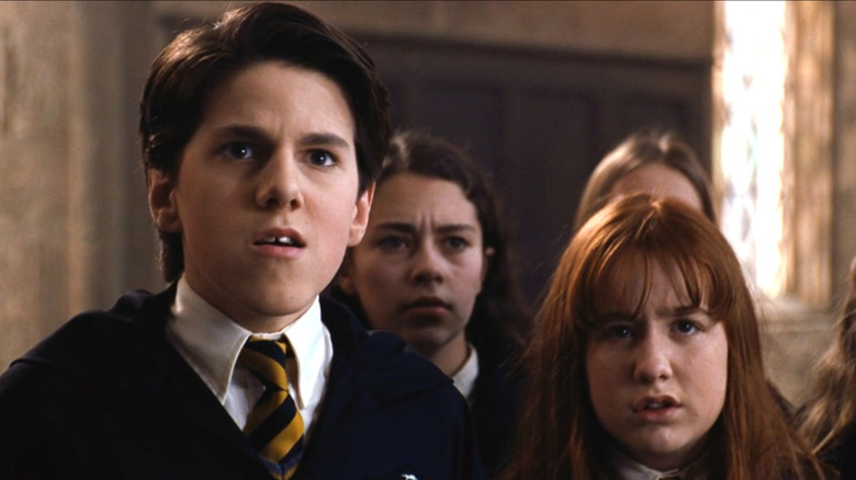 The Hufflepuff students giving Harry the stink eye in Harry Potter and the Chamber of Secrets