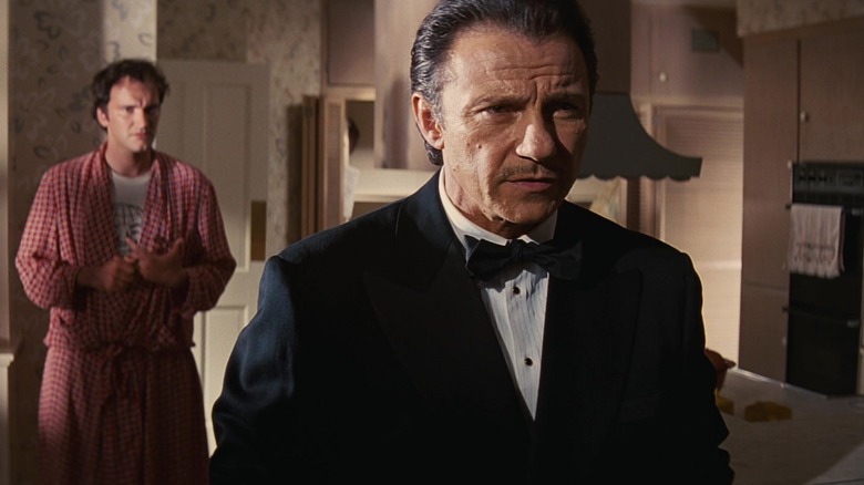 Winston Wolfe in a tuxedo with Desmond behind him in Pulp Fiction