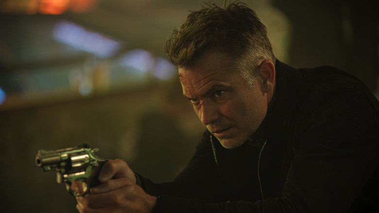 Timothy Olyphant's Vincent points a gun at someone off camera in Havoc