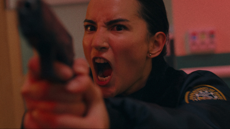 Jesse Mei Li's Ellie screams while pointing a gun at someone off camera in Havoc