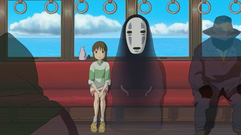 Chihiro and No Face on a train in Spirited Away