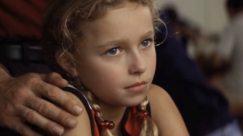 Hayden Panettiere as Sheryl Yoast sitting with someone's hand on her shoulder in Remember the Titans