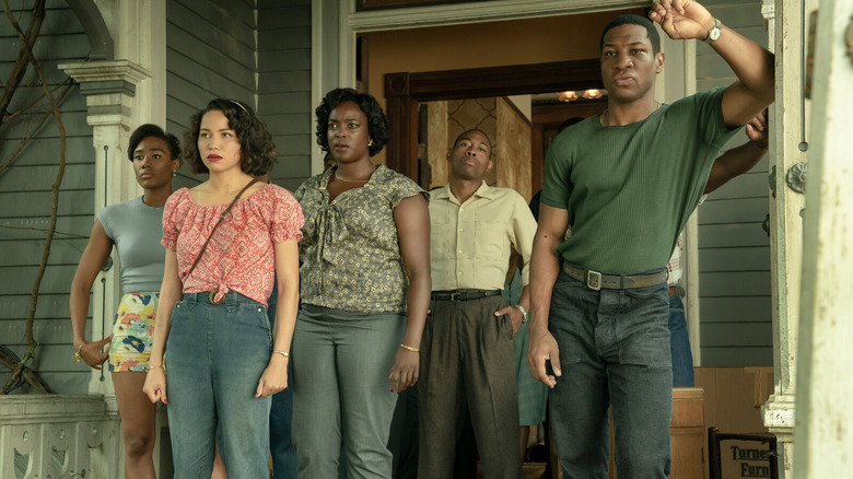Leti, Ruby, Tic, and their companions standing on a porch in Lovecraft Country