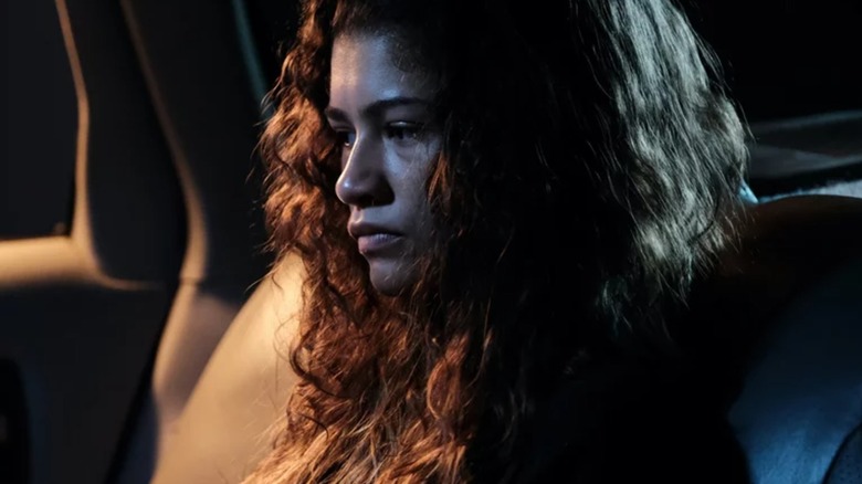 Zendaya's Rue looks somber in the backseat of a car in Euphoria