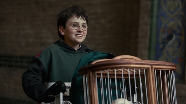 Harry pushing his cart through King's Cross in the