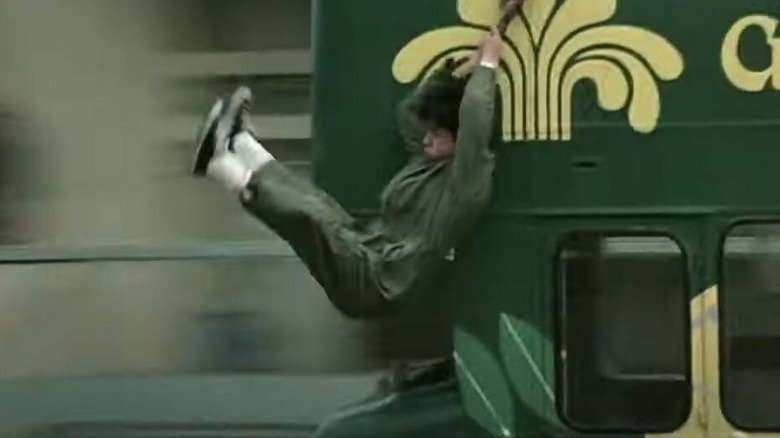 Chan Ka-kui hanging from a bus in "Police Story"
