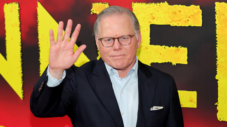 David Zaslav waves glumly on the red carpet at the premiere of Ryan Coogler's Sinners