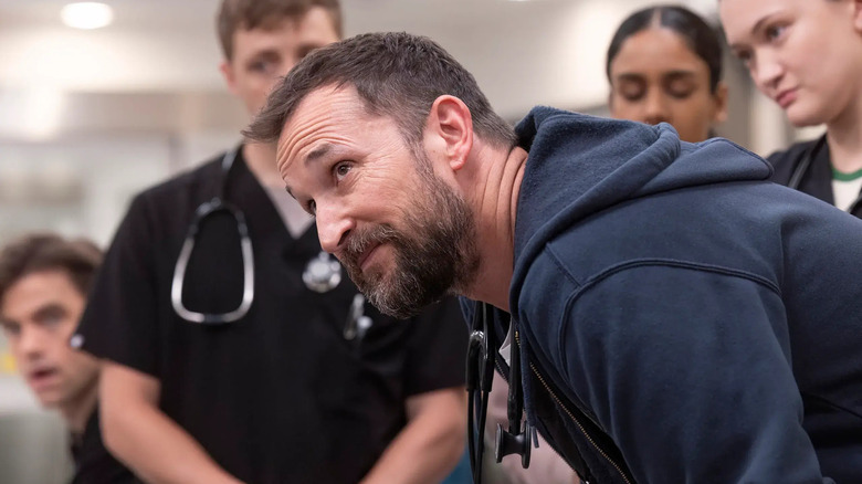 Dr. Robby looking up with a skeptical look on his face in The Pitt