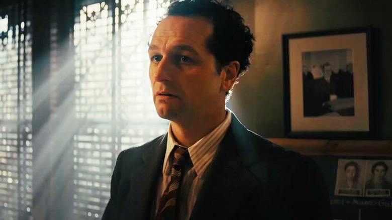Matthew Rhys as Perry Mason in suit in front of sunny window in Perry Mason