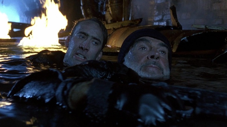 Nicolas Cage's Stanley Goodspeed swims behind Sean Connery's John Patrick Mason in The Rock
