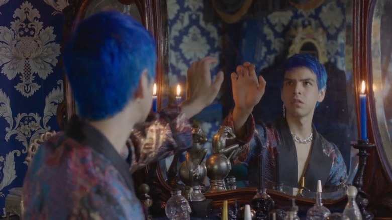 Julio Torres as Andrés Valdez reaching towards a mirror on Los Espookys
