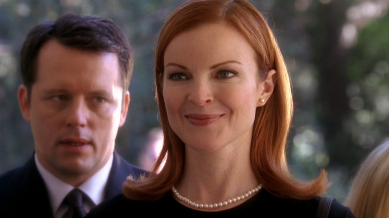 Desperate Housewives, Bree dressed up in funeral attire, her annoyed husband Rex in the background