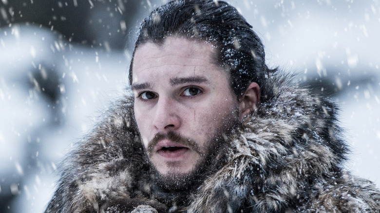 Jon Snow in the snow looking concerned on Game of Thrones