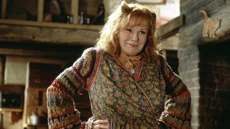 Molly Weasley smiling with her hands on her hips in Harry Potter and the Chamber of Secrets
