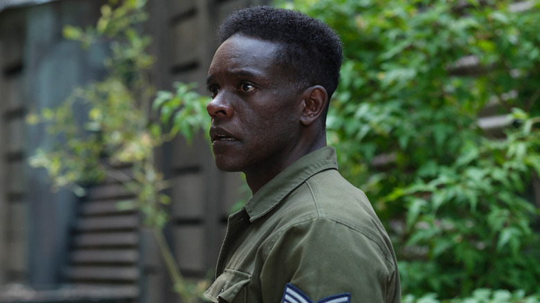Chris Chalk's Dick Hallorann is seen in standing outside wearing a military uniform in It Welcome to Derry