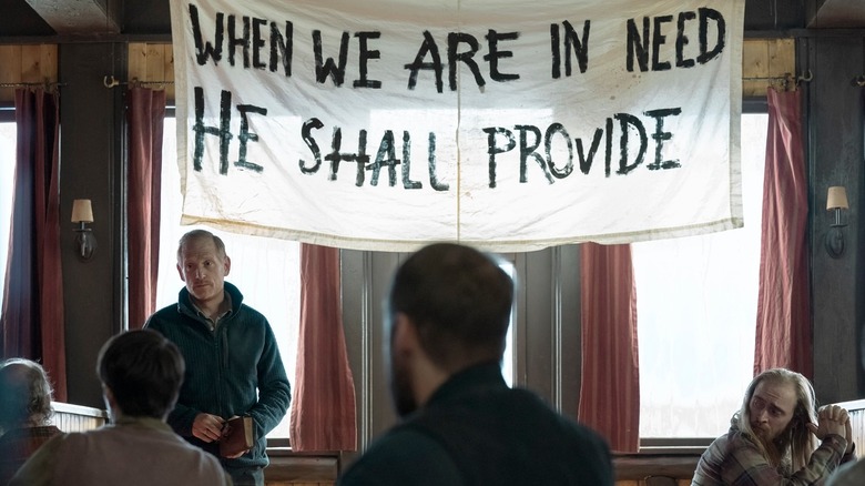 David's cult, with a banner that reads When We Are In Need He Shall Provide in The Last of Us
