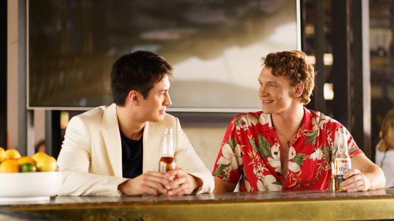 Shane and Ilya sharing a drink at a bar in Heated Rivalry