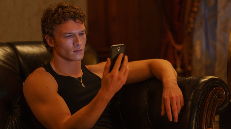 Connor Storrie as Ilya Rozanov texting in Heated Rivalry