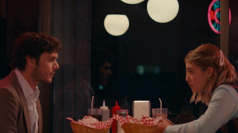 The Kid Detective - Abe (Adam Brody) and Caroline (Sophie Nelisse) sitting in diner booth