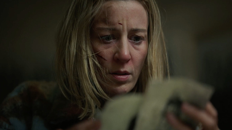 Vanessa Shepherd looks at photos in Hell House LLC: Lineage