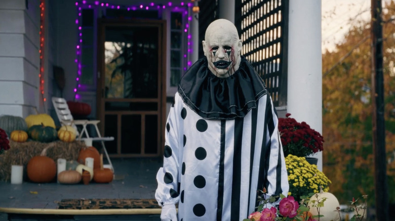 One of the Hell House LLC clowns stands in front of Halloween decorations in Hell House LLC: Lineage