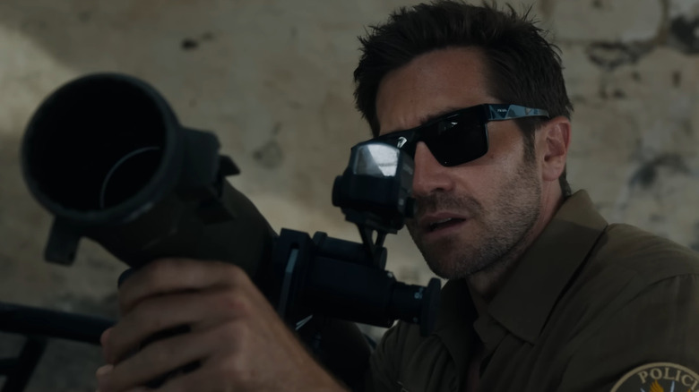 Jake Gyllenhaal as Bronco holding a bazooka in In the Grey