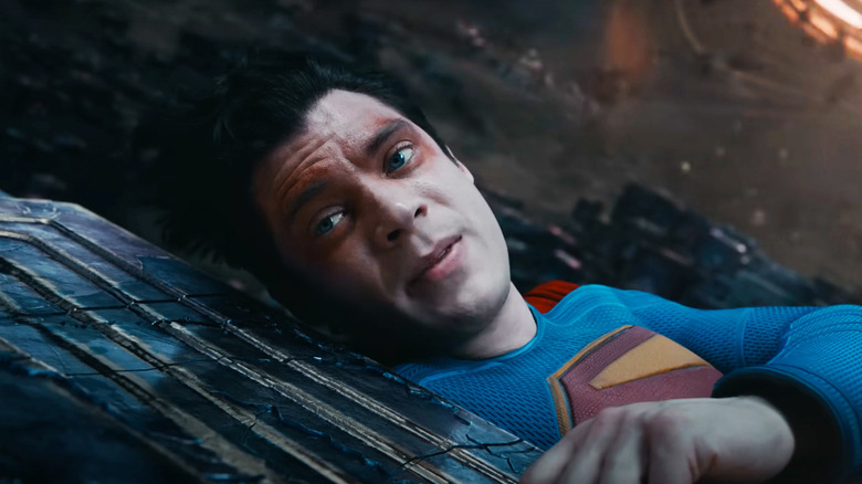 David Corenswet's Superman looks up while laying on pocket universe structures in Superman