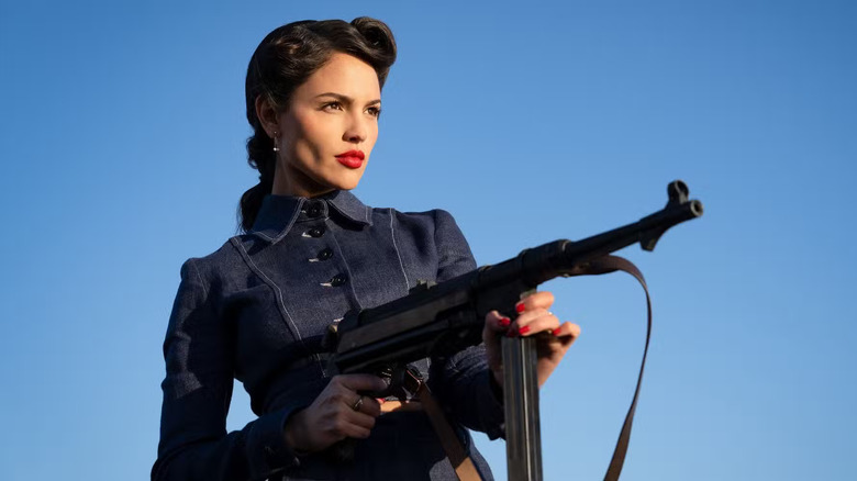 Lady Marling with a machine gun in The Ministry of Ungentlemanly Warfare