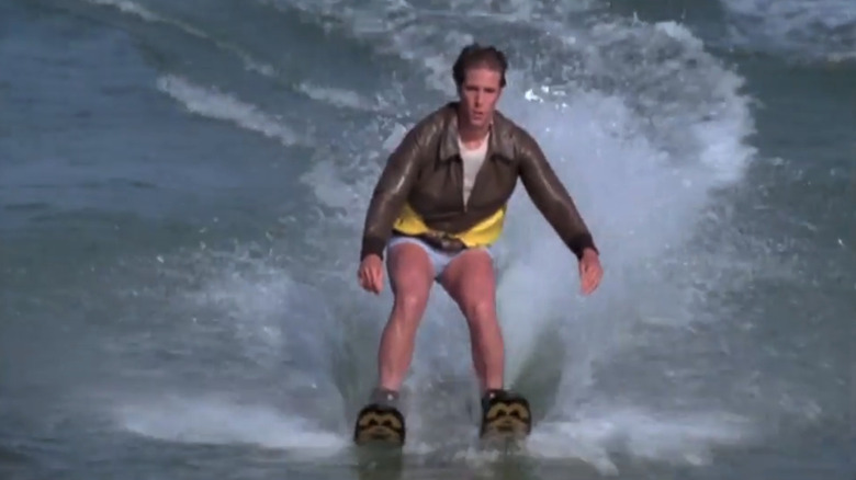 Henry Winkler as Fonzie water skis wearing a yellow life preserver in Happy Days