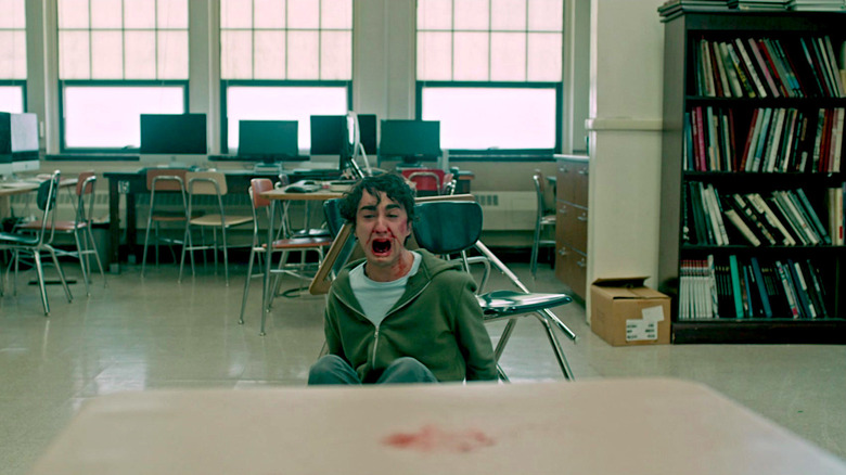 Peter falls to the floor after smashing his head on his desk