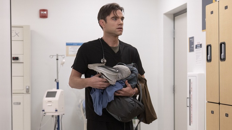 Langdon holding his belongings in the locker room on The Pitt