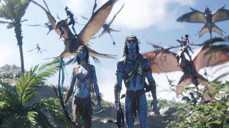 Neytiri and Jake Sully march into battle with Ikran behind in Avatar: Fire and Ash