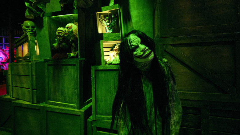 A creepy smiling monster wanders the halls at Universal Horror Unleashed