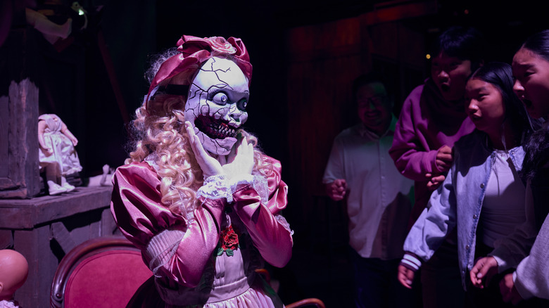 A demonic doll monster menaces the crowds at Universal Horror Unleashed