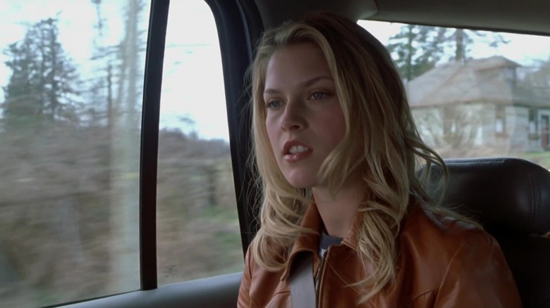 Ali Larter in car in woods