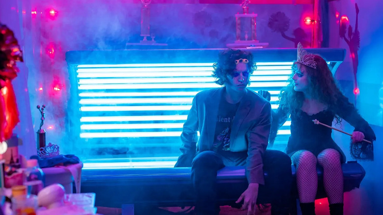 Lisa and the Creature sitting on the tanning bed in Lisa Frankenstein